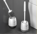 Two toilet cleaning brushes with holders on a gray surface, featuring the MENGNI brand.